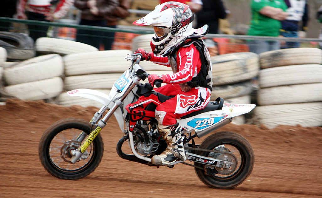Joel Kelso astride his 50cc Husqvarna in open-throttle action on the dirt track. Joel Kelso astride his 50cc Husqvarna in open-throttle action on the dirt track.